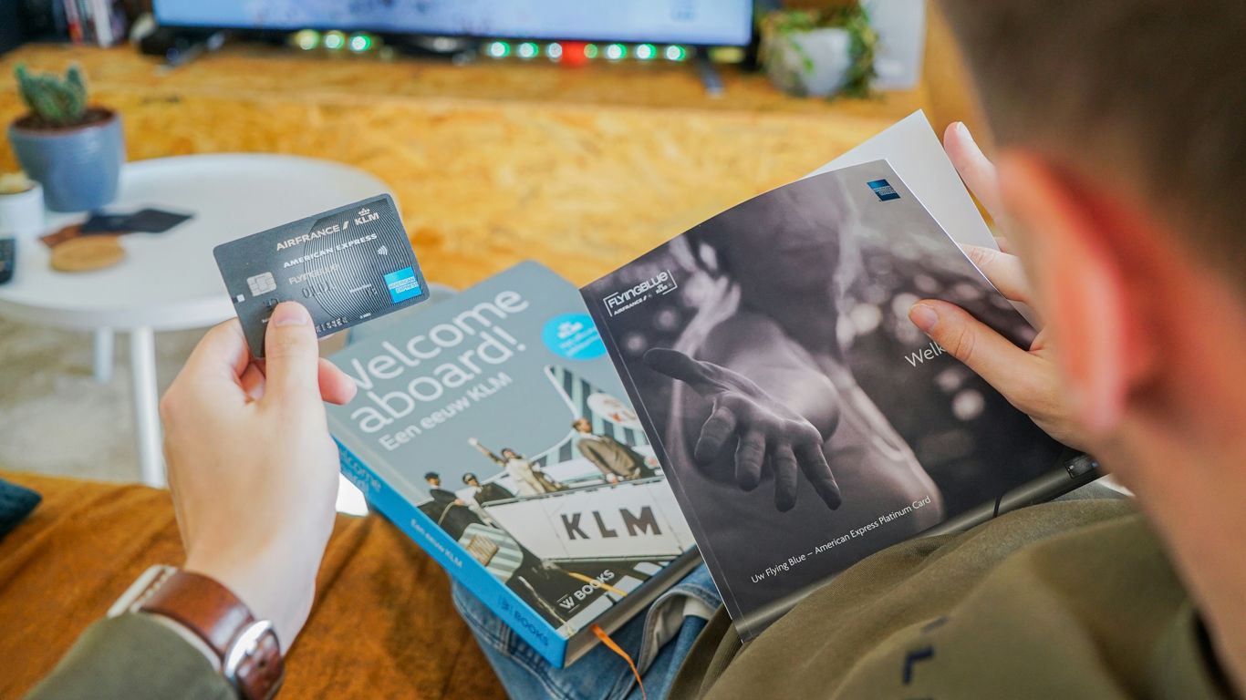a man reading a book in front of a television