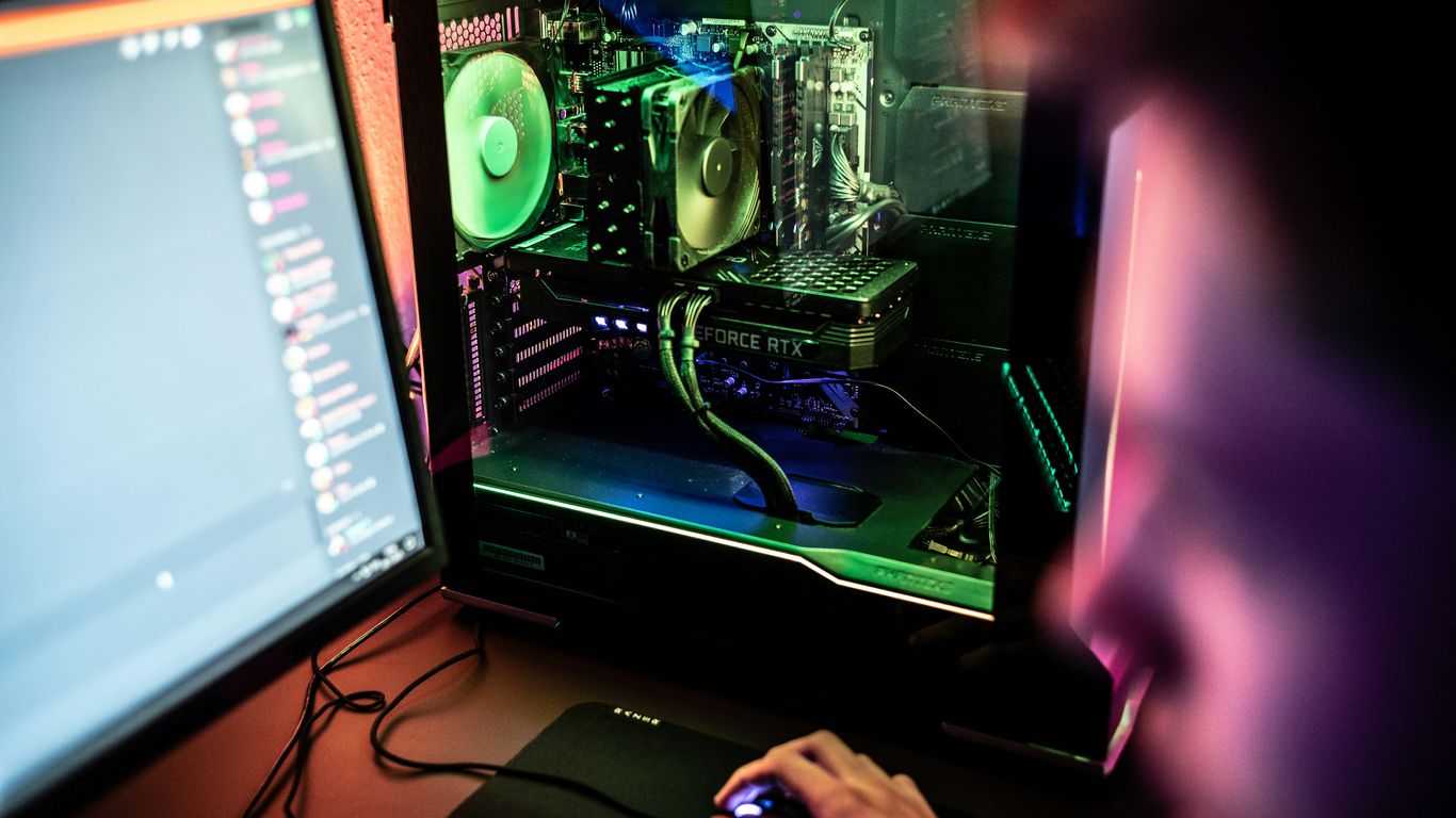 a person is working on a computer with a mouse