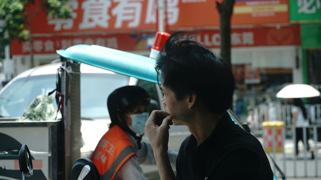 Man in black shirt looking away from camera