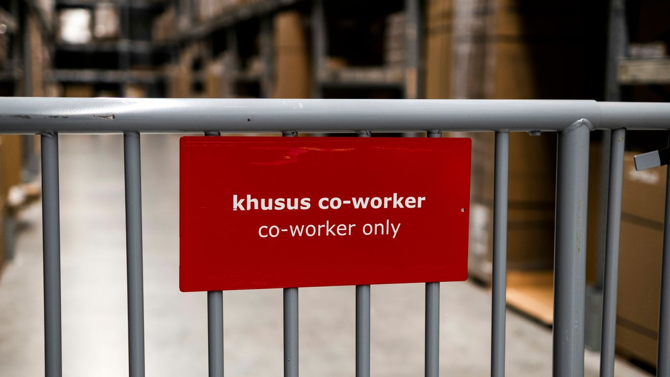 a red sign that is on a metal fence