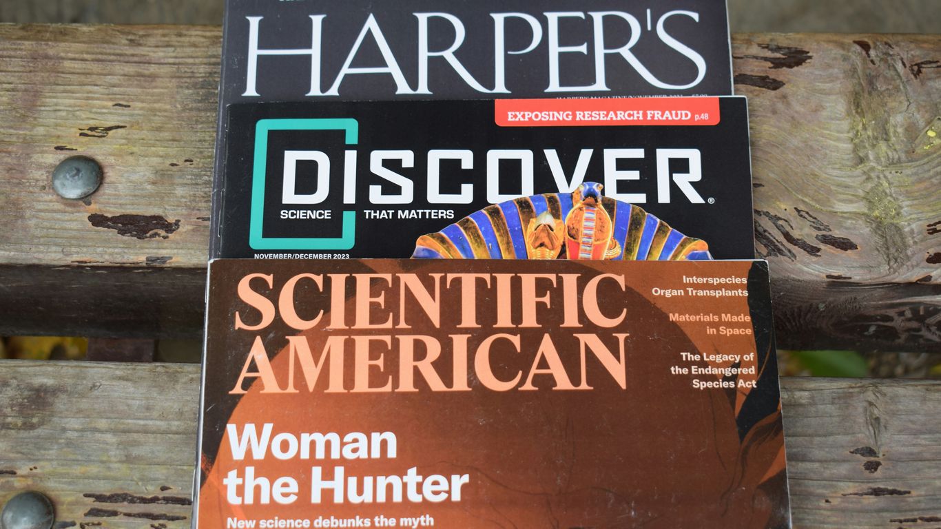 a book sitting on top of a wooden bench