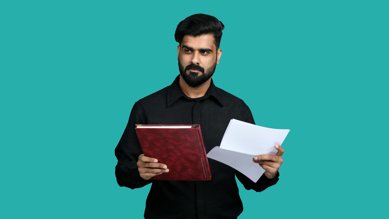 a person holding a book and a pen