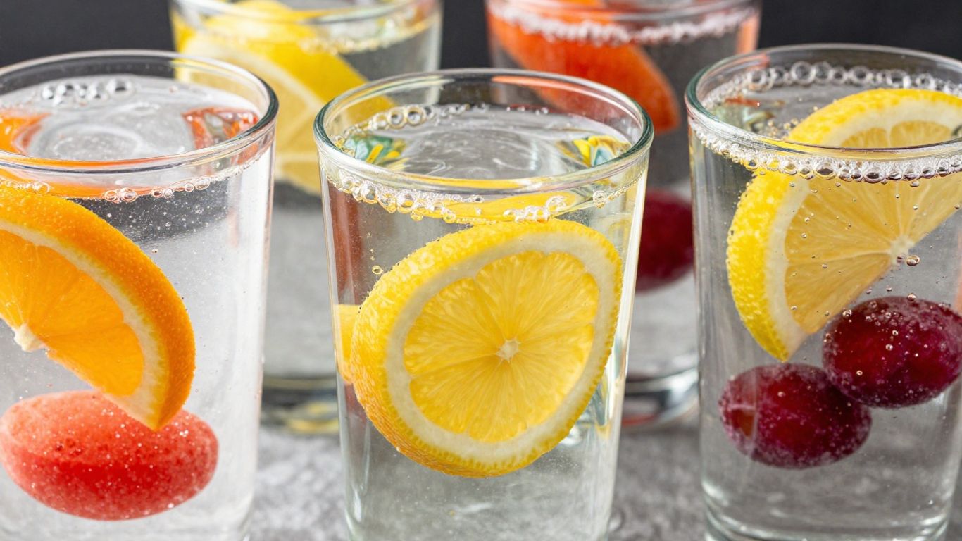 Colorful Herbalife Liftoff tablets dissolving in water.