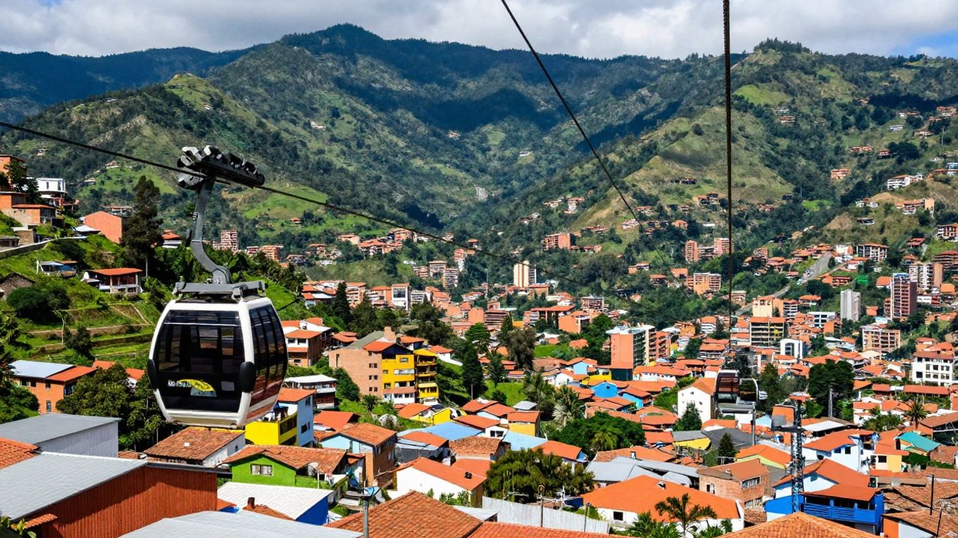 Colorful Medellin cityscape with cable car and mountains.