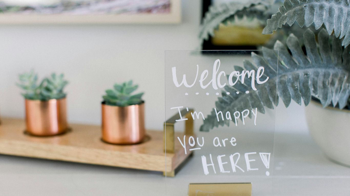 A small tabletop sign in an L-shaped acrylic holder
