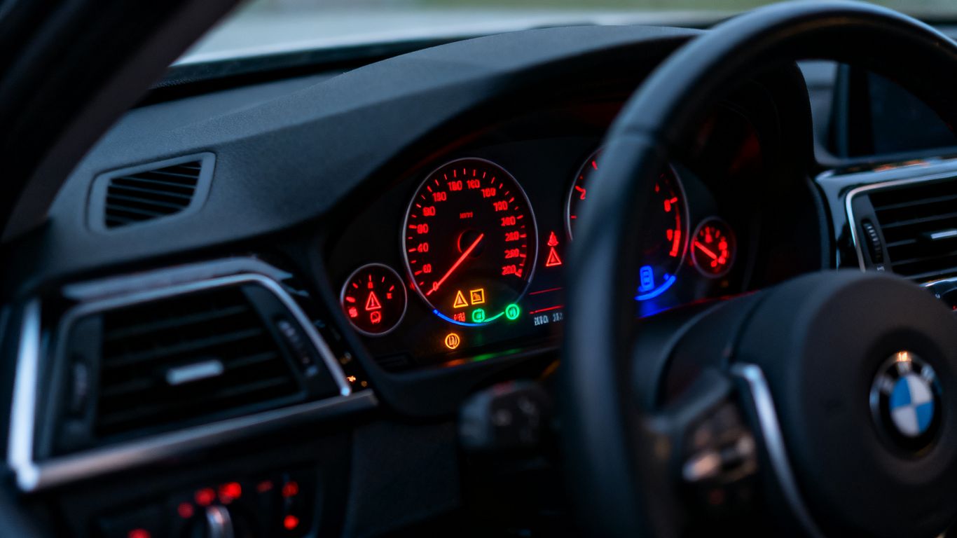 Close view of illuminated BMW dashboard warning symbols