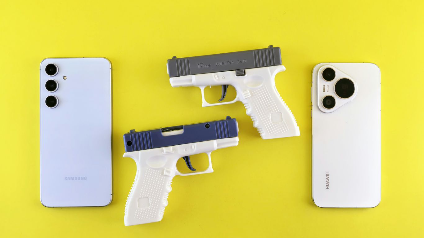 Two toy guns between two smartphones