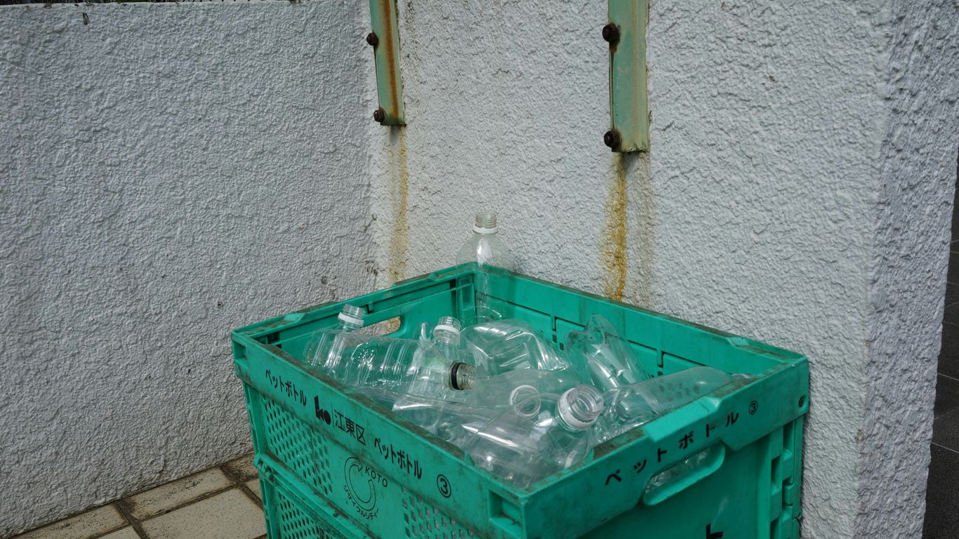 Green bin filled with empty plastic bottles