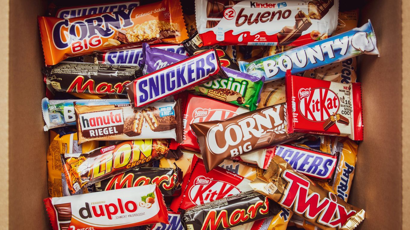 Assorted packaged snack bars on a wooden table