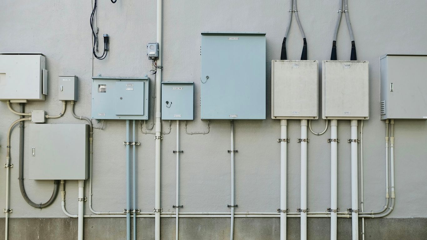 a bunch of electrical wires are attached to a wall