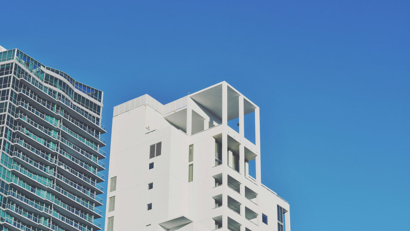 a tall white building sitting next to a tall white building