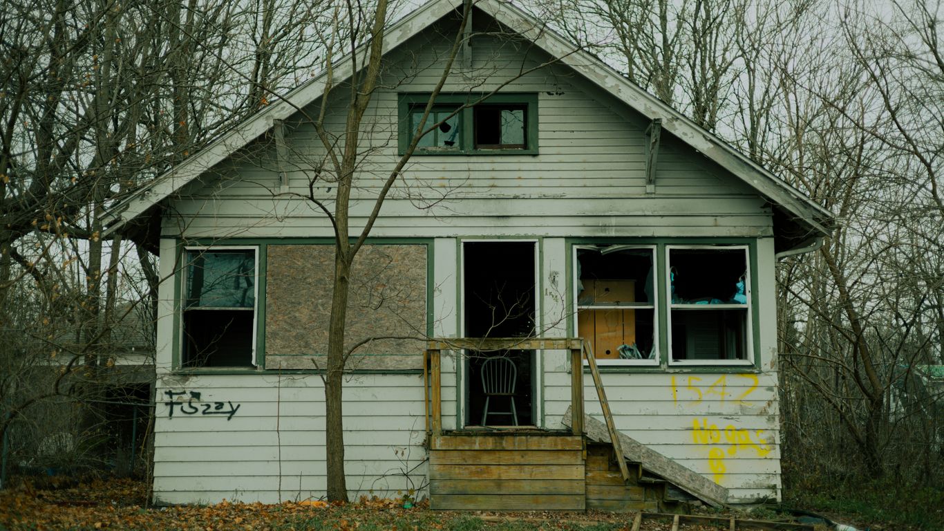 a white house with trees around it