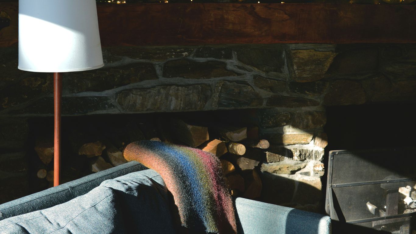 a living room with a couch and a lamp