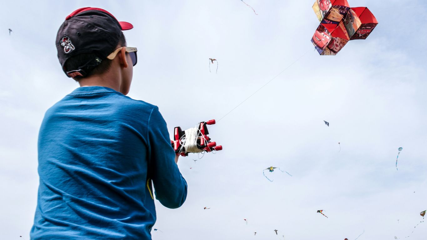 Families flying kites on the roof