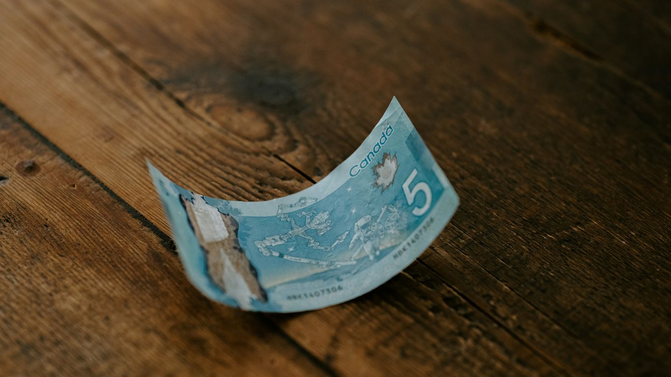 20 banknote on brown wooden table