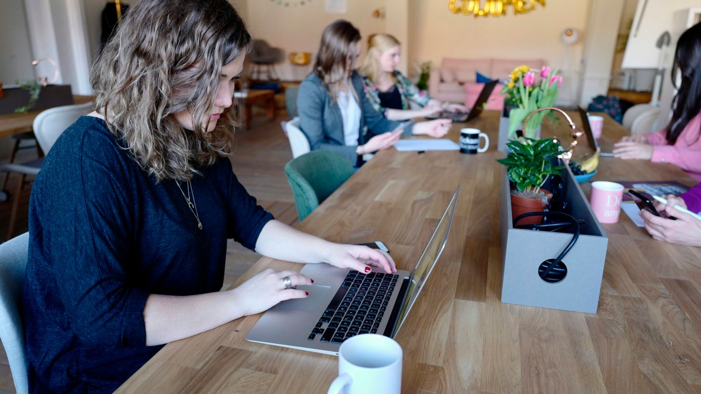 woman using MacBook in room