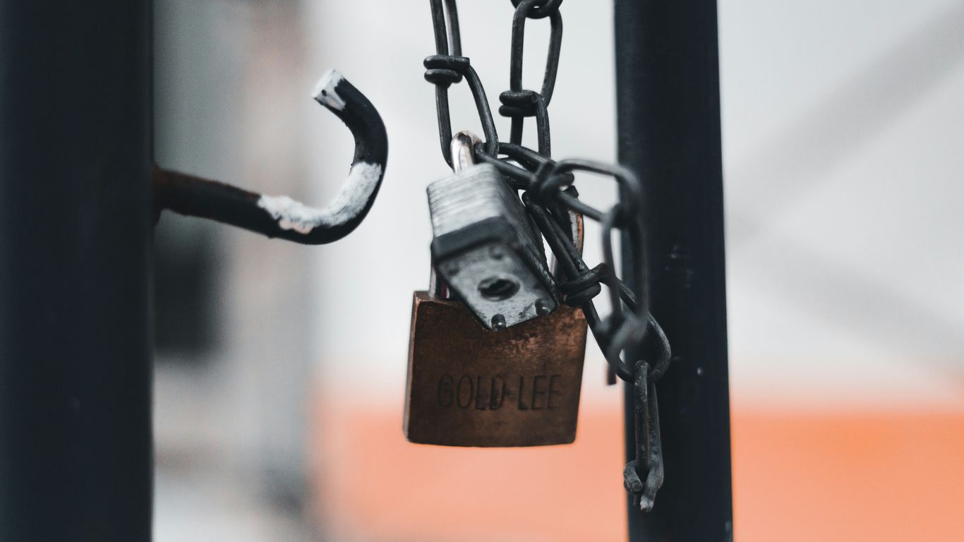 a padlock attached to a metal pole