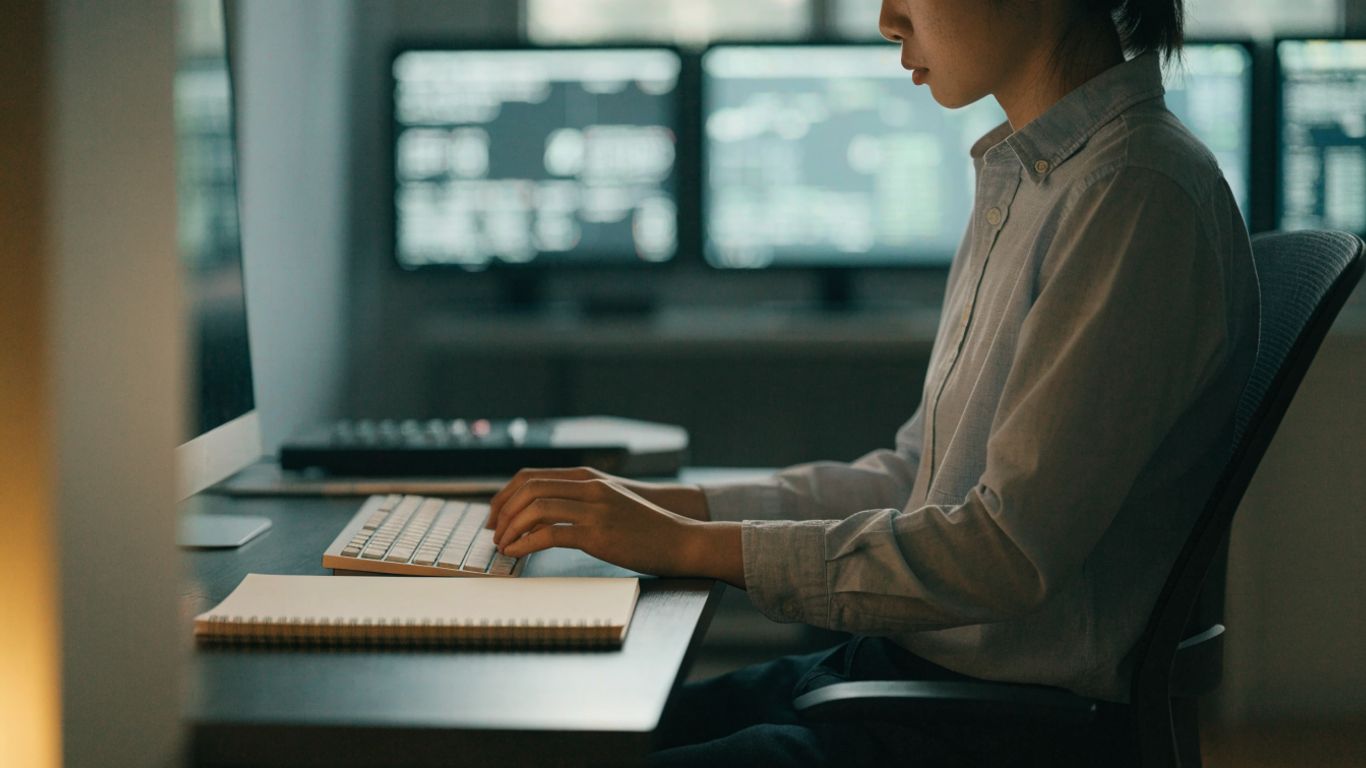 Trader studying market conditions at a desk with charts on screen