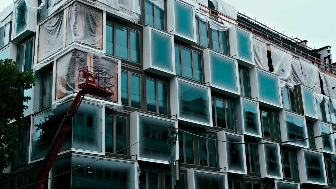 Modern building under construction with unique window design.