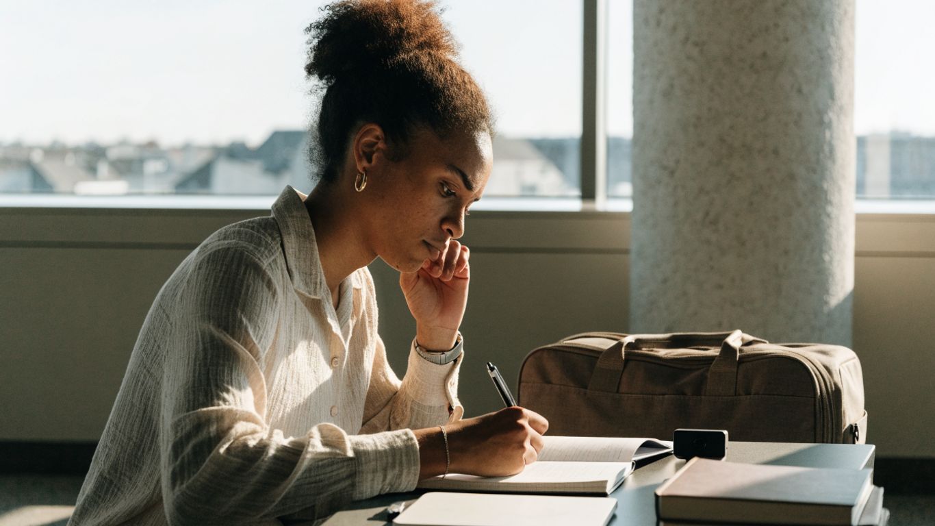 Assignee reviewing notes before a cross-cultural meeting