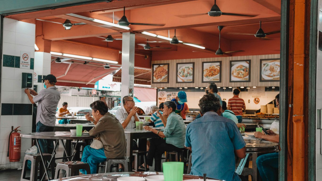 A vibrant hawker centre under moonlight