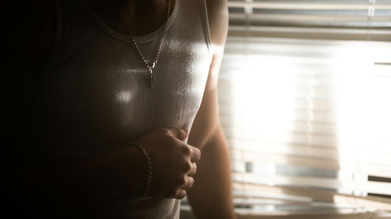A woman standing in front of a window