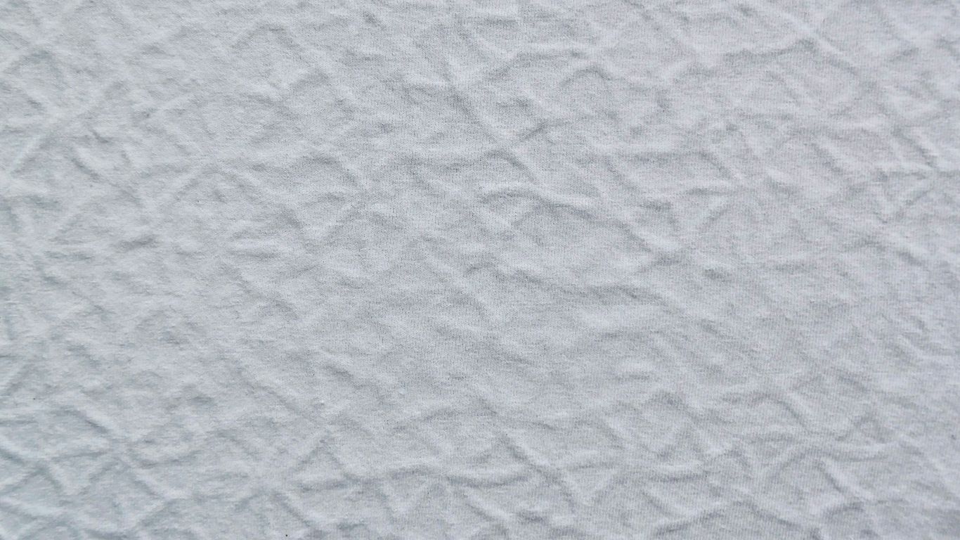 a close up of a white textured wall