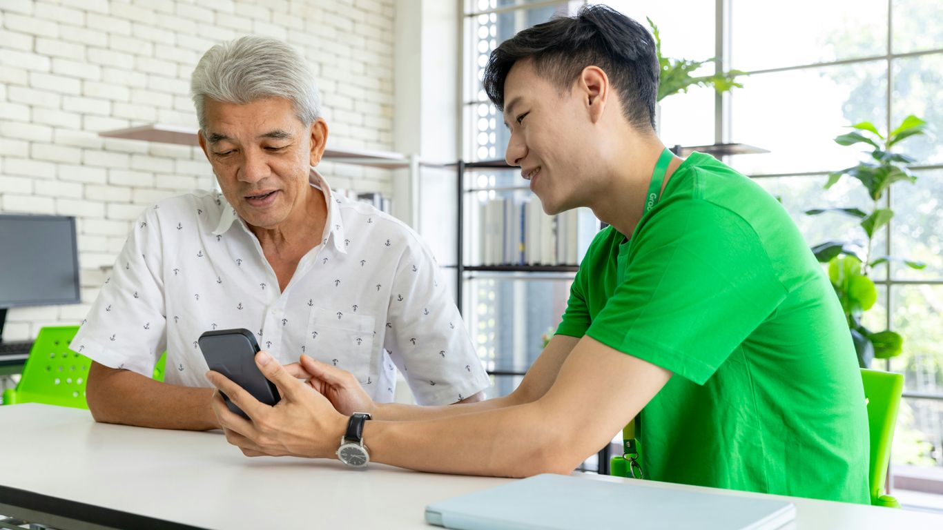 a man and a woman looking at a cell phone