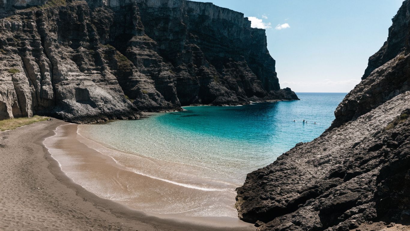 Dark volcanic cliffs above a Mediterranean cove