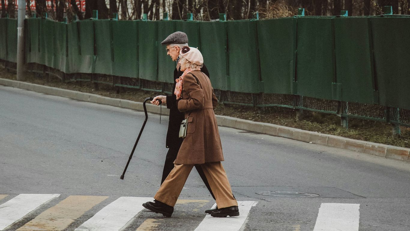 man and woman walking on pedestrian line during daytime