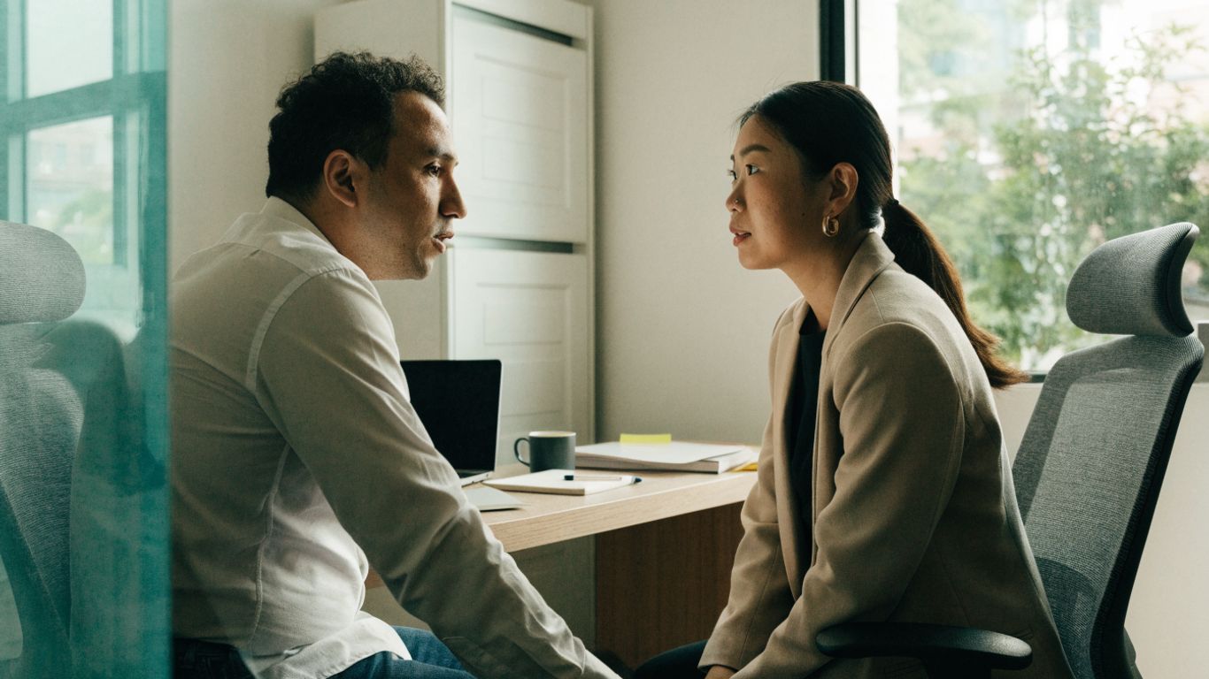 Patient speaking with a chiropractor in a calm clinic