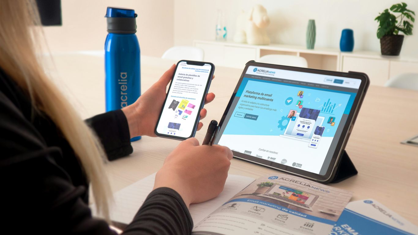 a woman sitting at a table using a tablet