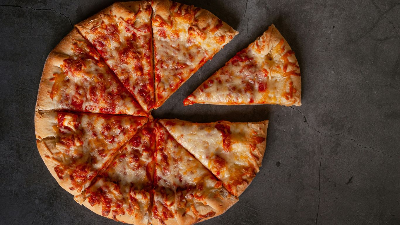 a sliced pizza sitting on top of a table
