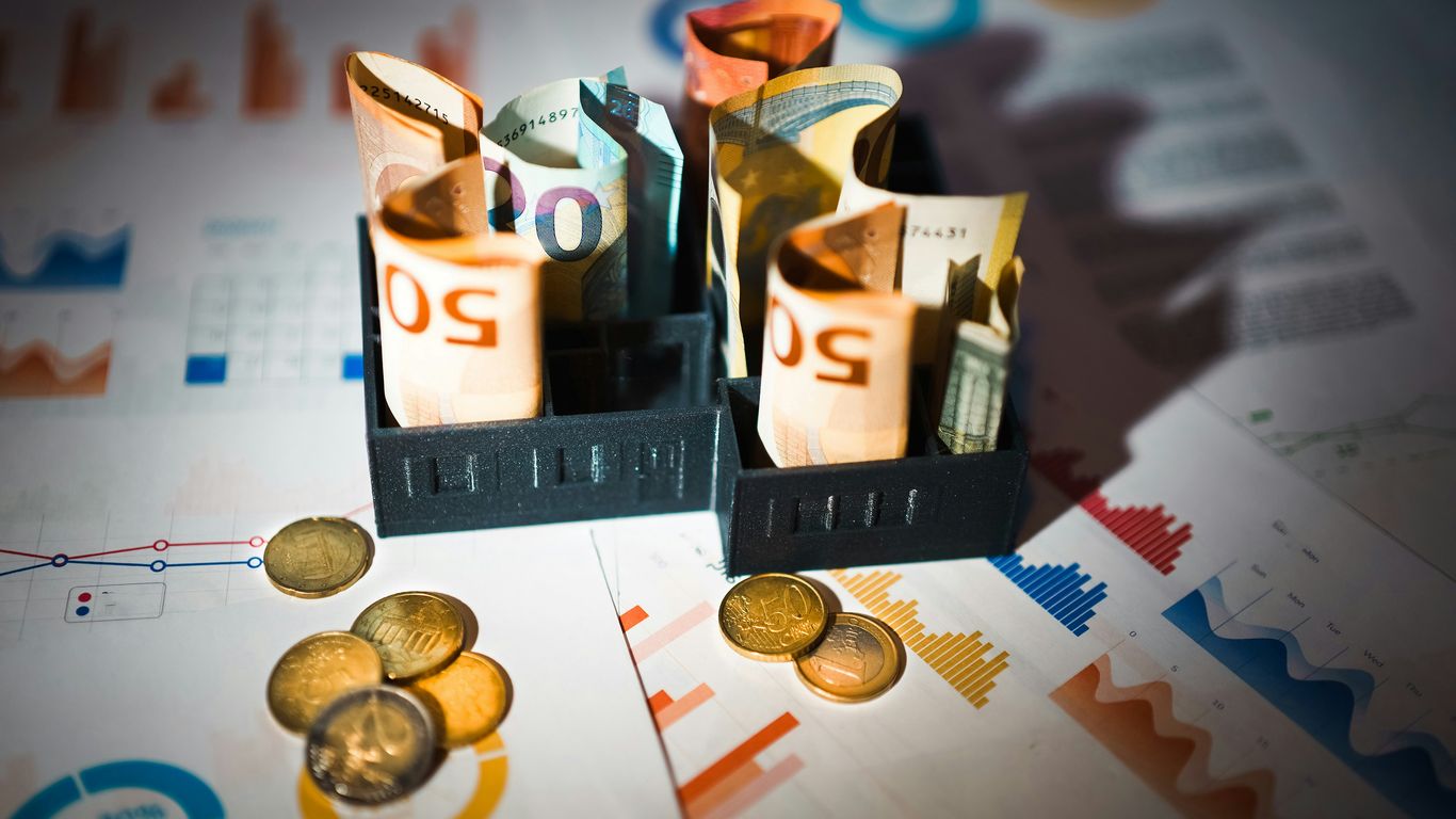 A pile of money sitting on top of a table