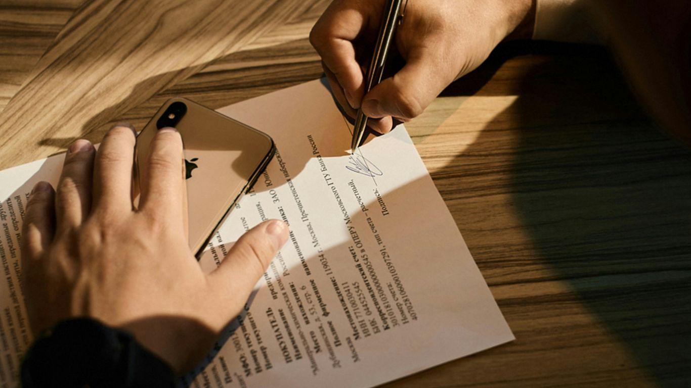 person writing on white paper