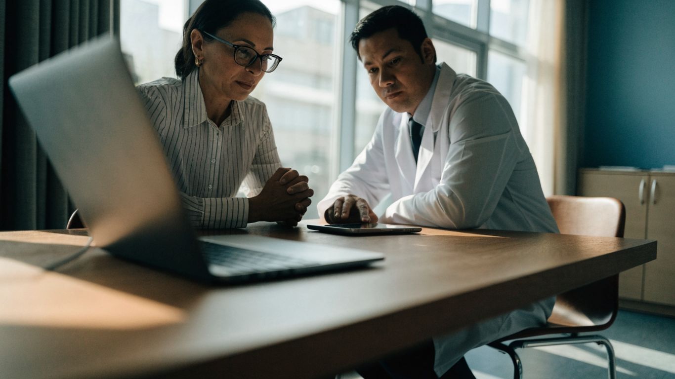 Staff checking a secure clinic workflow