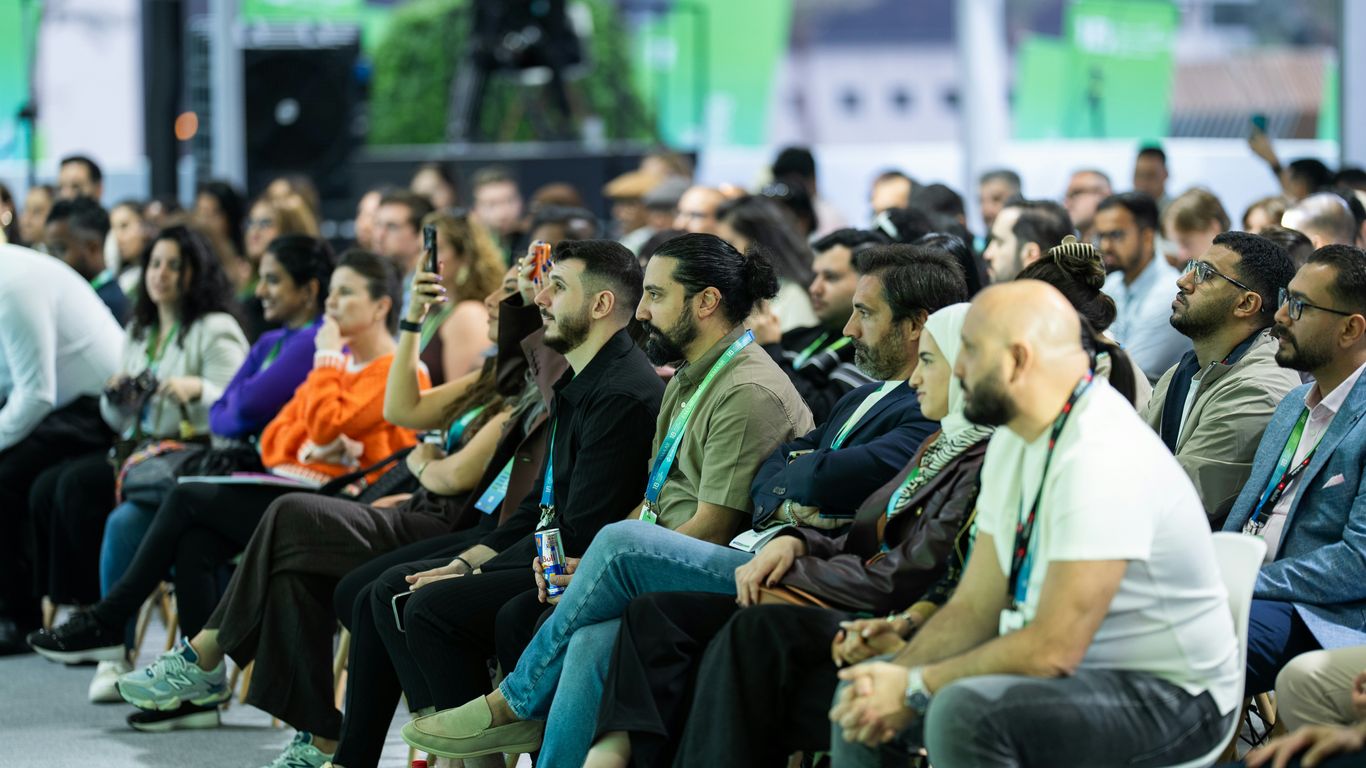 Diverse audience attentively listening at a conference event.