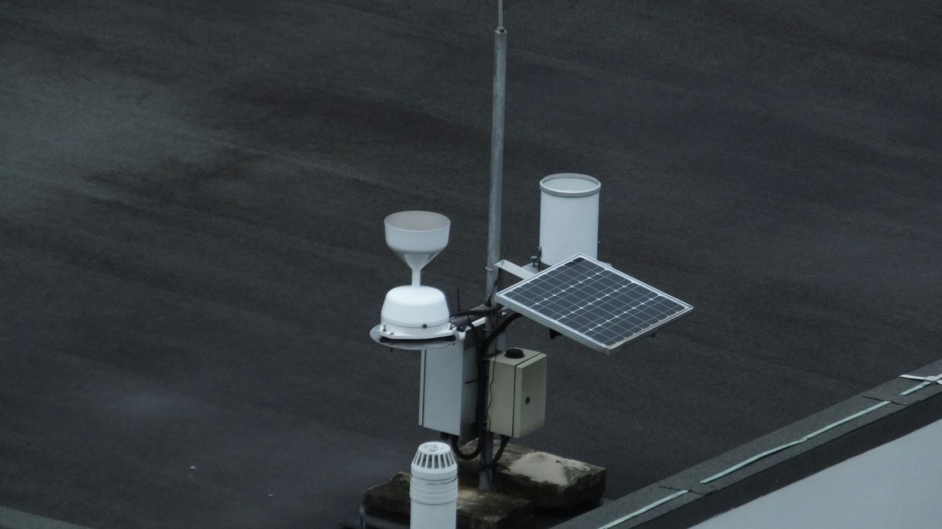 A weather monitoring station in a rural landscape