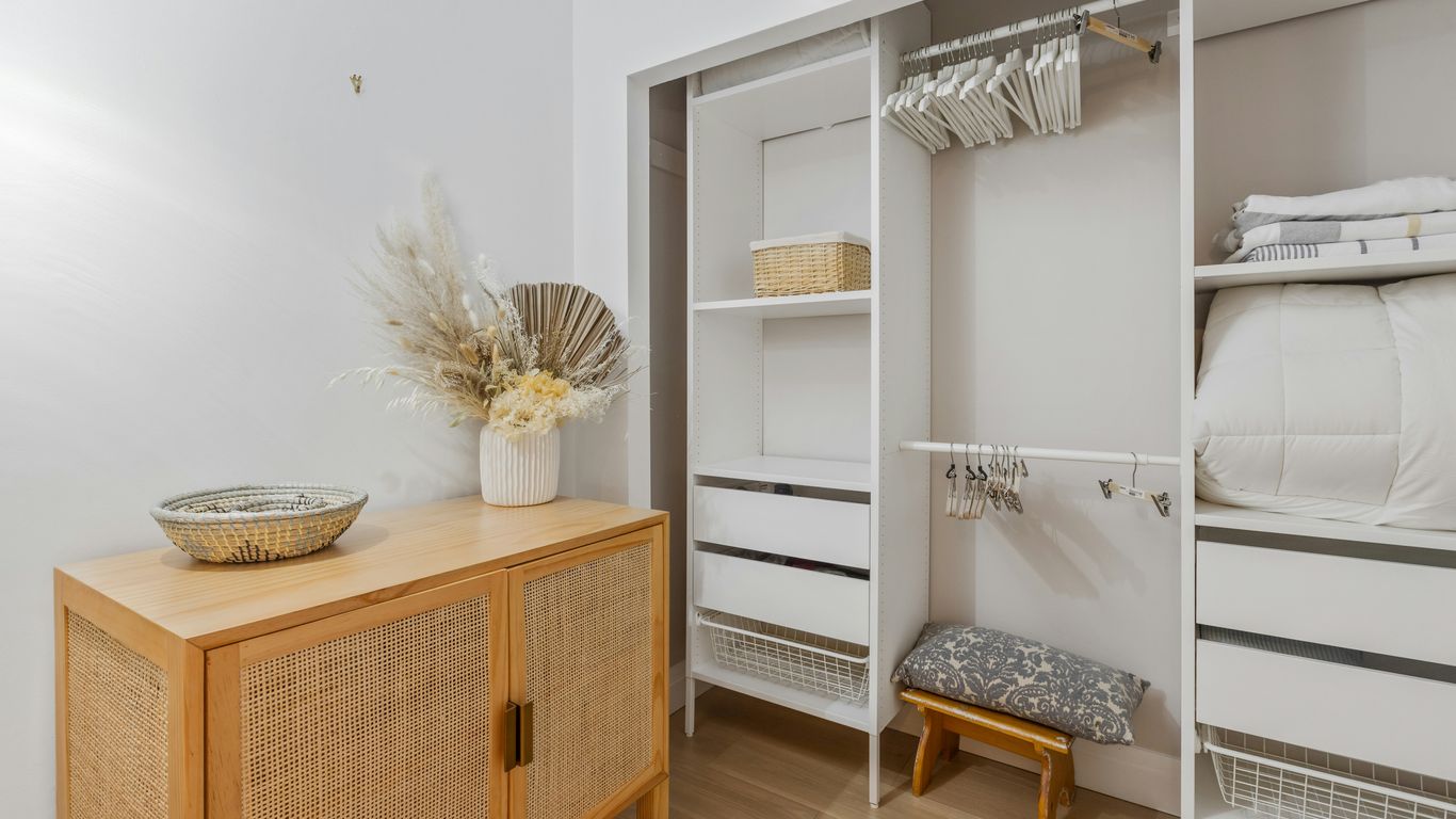 brown wooden bed frame with white bed mattress