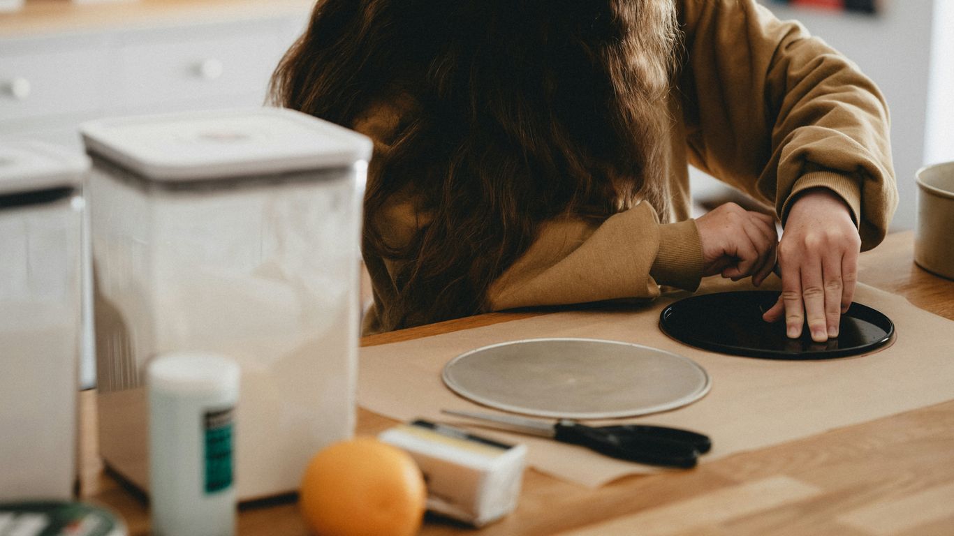 woman in brown long sleeve shirt sitting at the table