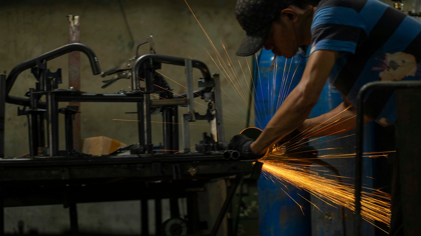 a man working on a machine in a factory
