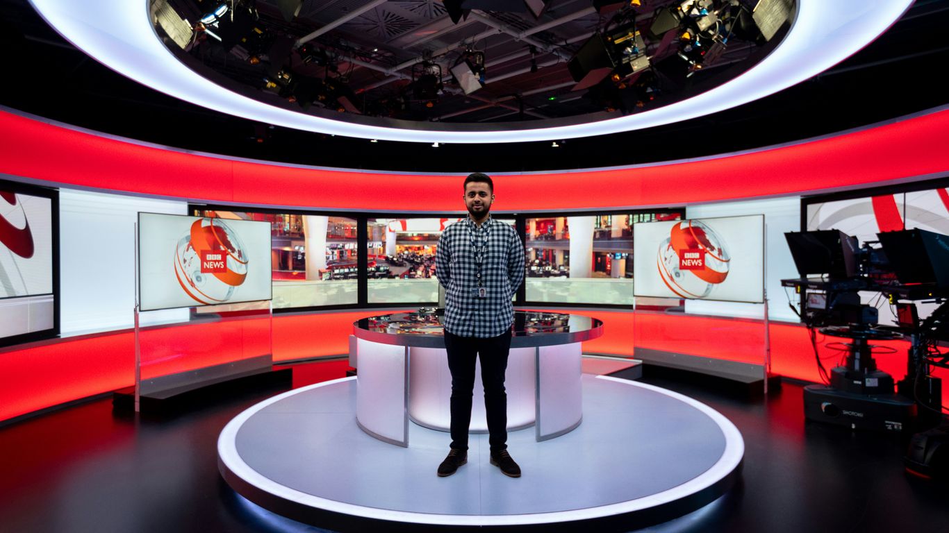 Presenter explaining a lesson in a bright studio
