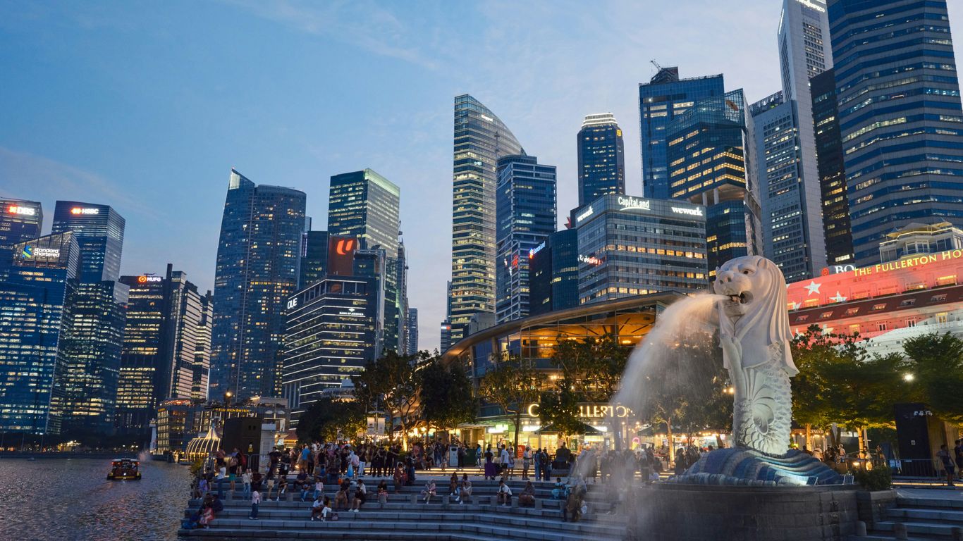 a city skyline with a fountain in the foreground