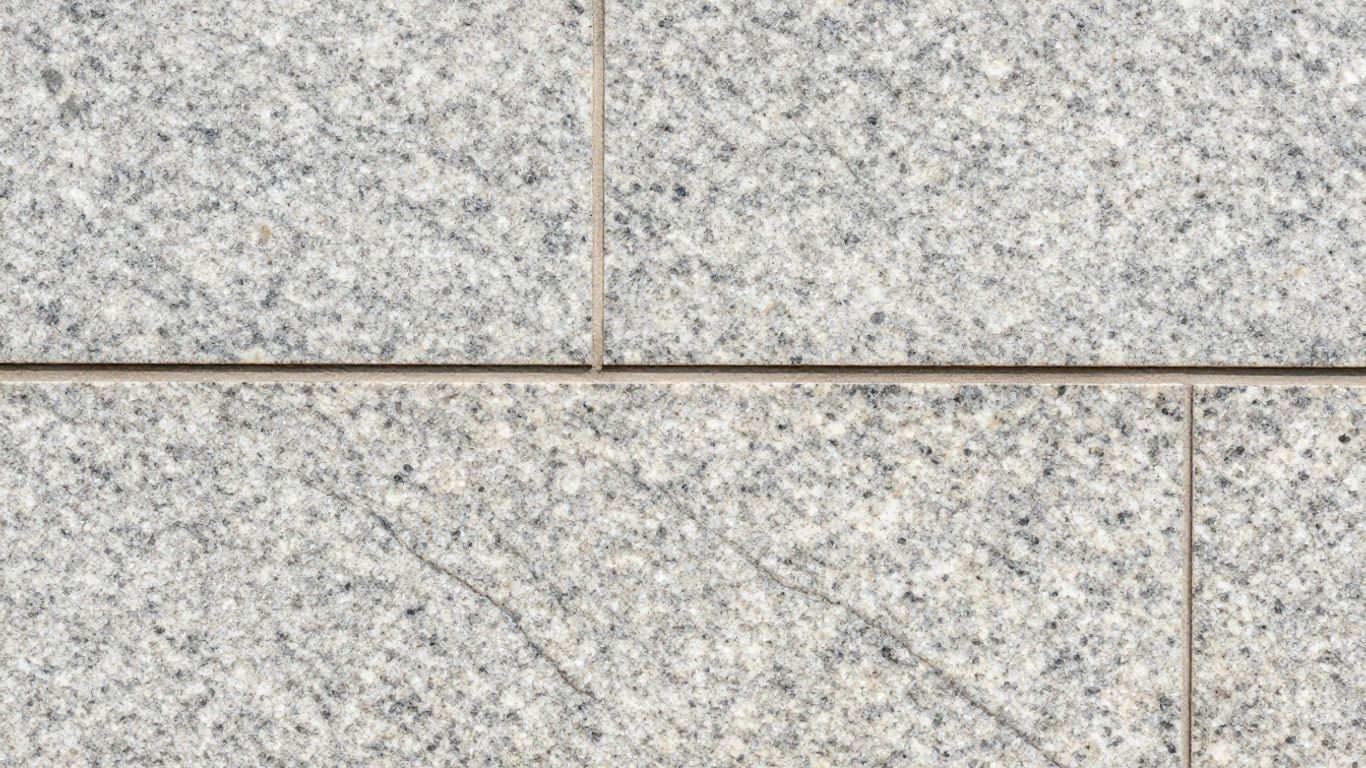 Polished granite building facade with natural veining.