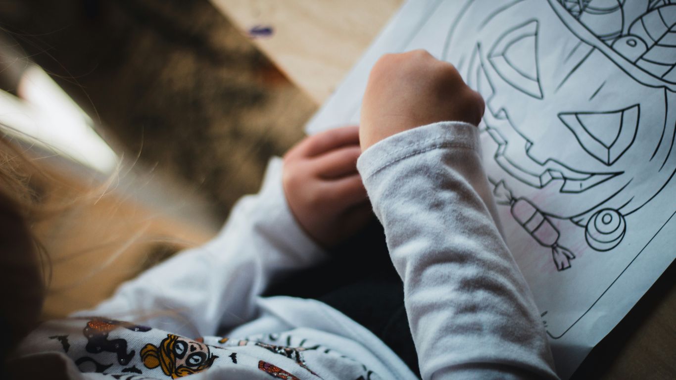 a person drawing on a paper