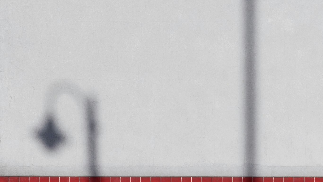 a shadow of a street light on a wall