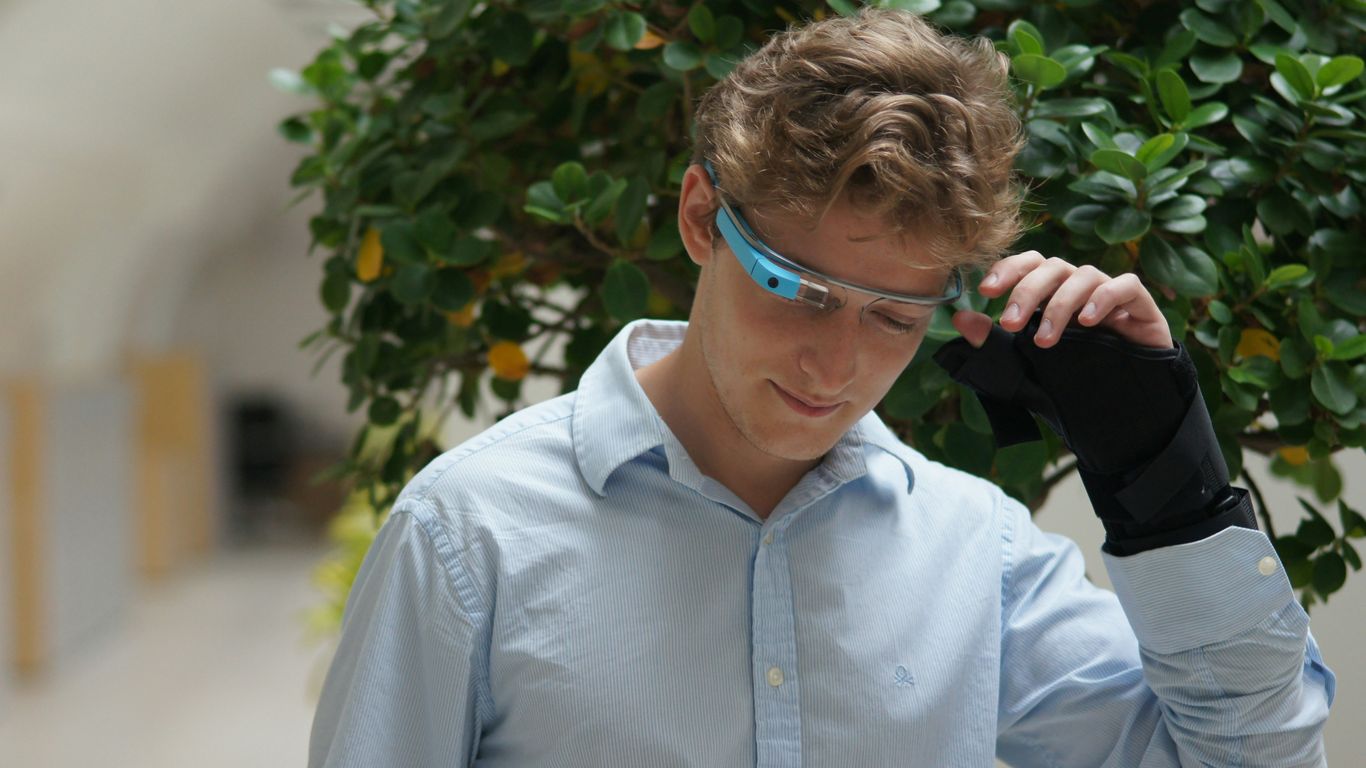 man in blue dress shirt wearing blue framed eyeglasses
