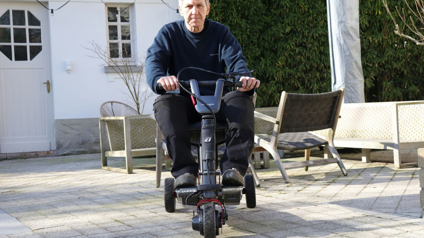 Man riding a mobility scooter outdoors