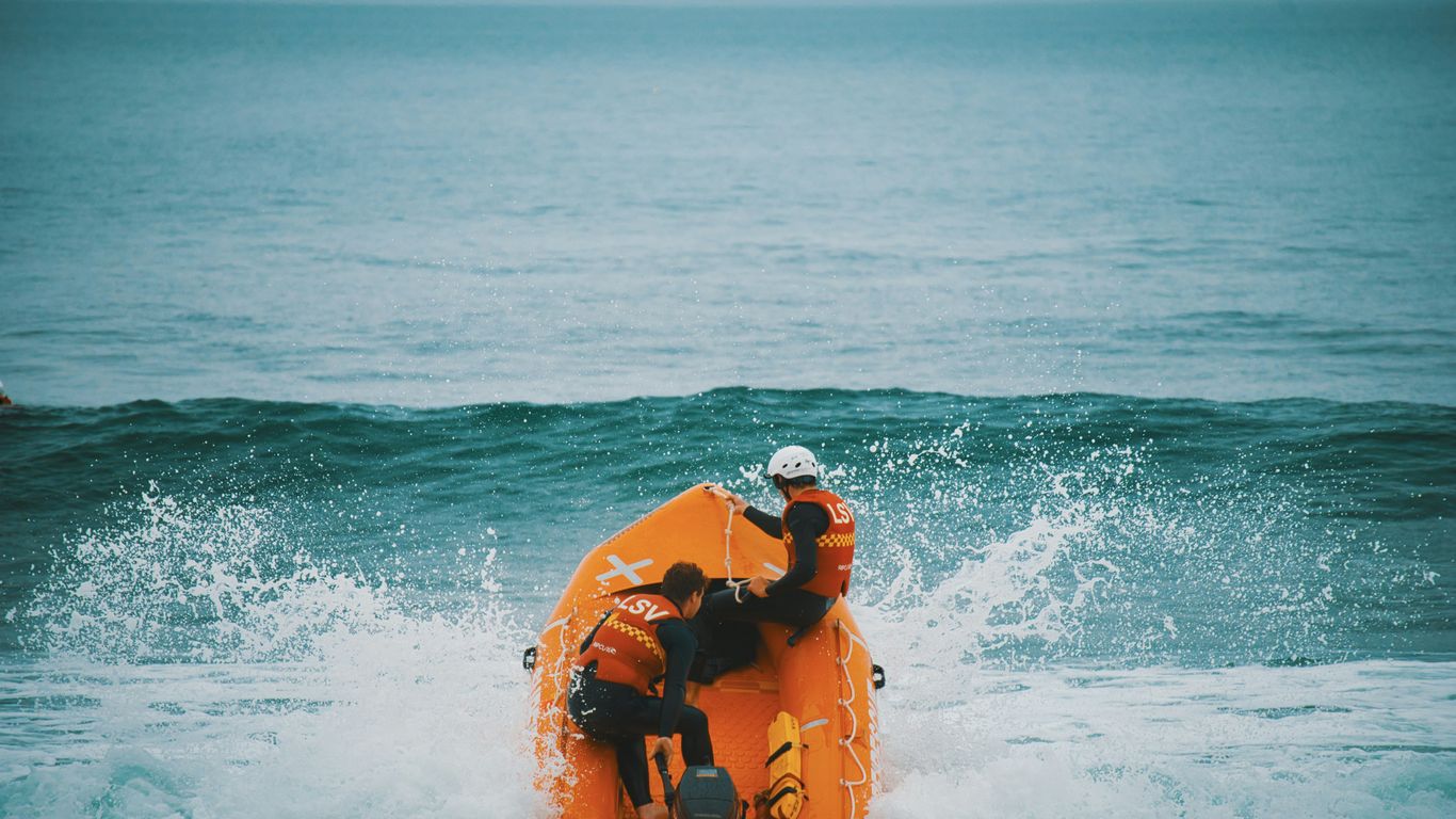 two people on an orange raft in the ocean