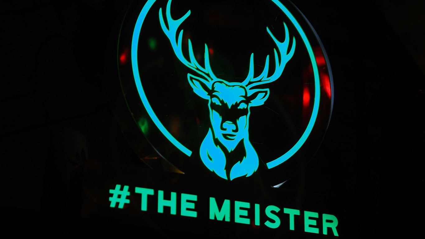 a neon sign with a deer's head on it